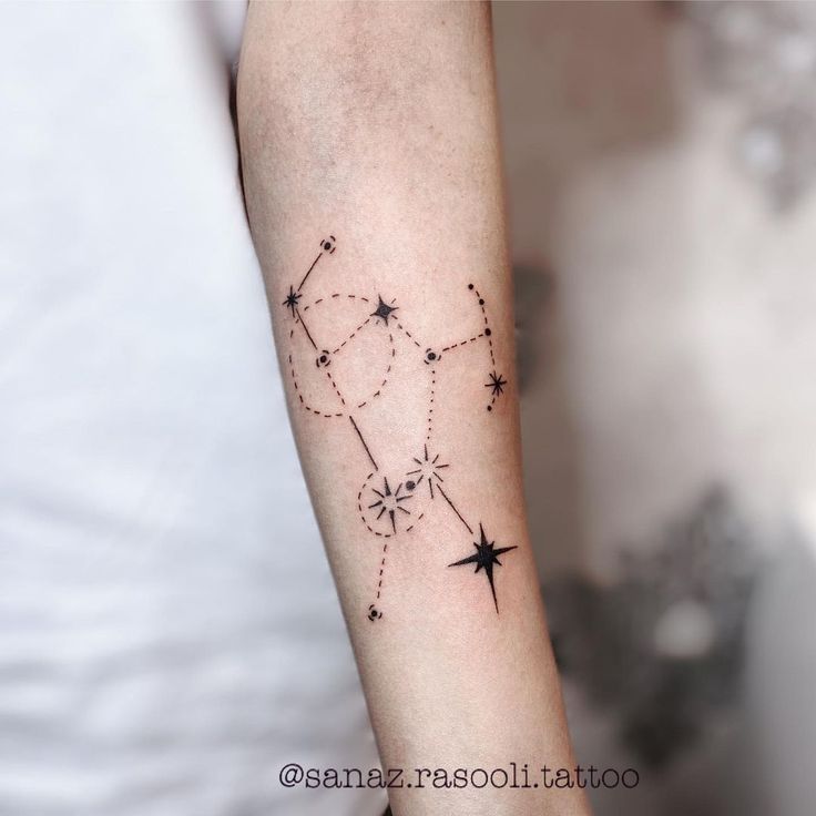 a woman's arm with a star tattoo on it