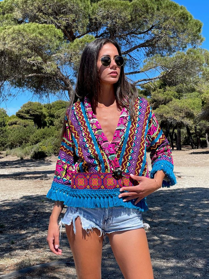 An astonishing boho summer jacket that has been hand woven with colorful tribal patterns. Perfect for lovers of eccentric statement pieces. Works amazingly well with solid colors as well as with bold prints such as animal prints. A unique, vibrant, piece, for people of style. Stylish elegant and bold, this jacket is a rare, statement piece that you will wear a lot and absolutely adore. In your vacations or in the city, this is key piece for your summer wardrobe. Our model, wears SIZE Medium and Summer Long Sleeve Outerwear With Boho Print, Summer Boho Print Long Sleeve Outerwear, Bohemian Multicolor Patterned Kimono, Bohemian Patterned Multicolor Kimono, Summer Long Sleeve Boho Print Outerwear, Bohemian V-neck Summer Outerwear, Long-sleeved Tassel Kimono For Festivals, Summer Bohemian Long Sleeve Outerwear, Long Sleeve Kimono With Tassels For Festival