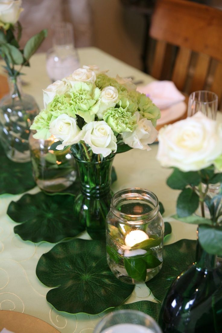 there are many vases with flowers on the table