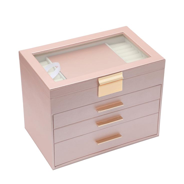 a pink jewelry box with gold handles and drawers