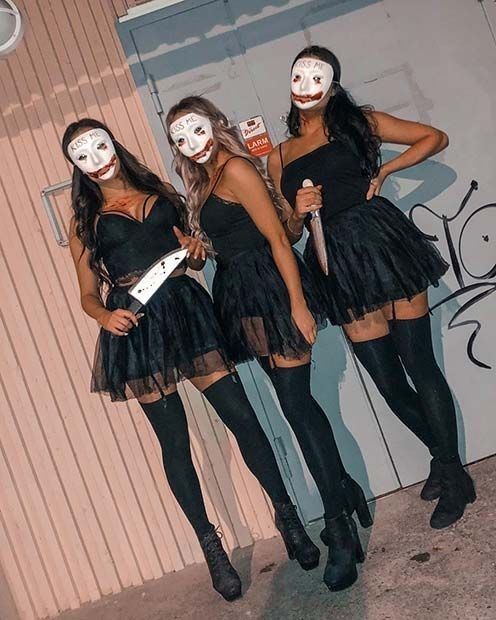 three young women dressed in costumes posing for a photo with their faces painted white and black