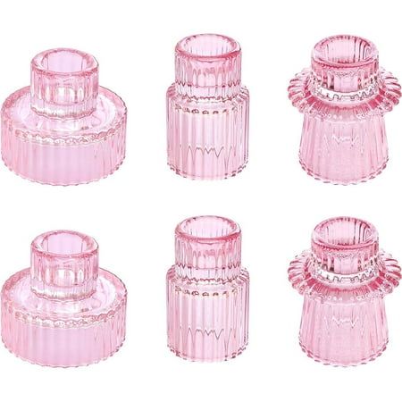 four pink glass jars are shown on a white background