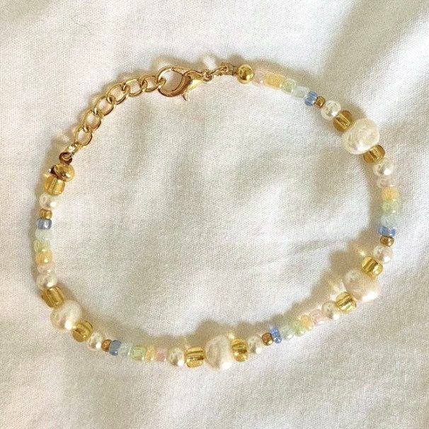 Beaded Bracelet   Hand beaded - real fresh water pearls and seed beads It is not recommended to wear bracelets or necklaces in water - swimming, showering etc.   Delicate - handle with care Adjustable in size! Summer Gold Beaded Pearl Bracelet, Pearl Beaded Bracelets With Gold And Round Beads, Beaded Round Pearl Bracelet, Gold Pearl Bracelet With Colorful Beads For Beach, Handmade Gold Pearl Bracelet For Summer, Adjustable Pearl Beaded Bracelets, Pearl Bracelet With Tiny Round Beads, Pearl Bracelet With Beaded Round Beads, Beaded Pearl Bracelet With Round Beads