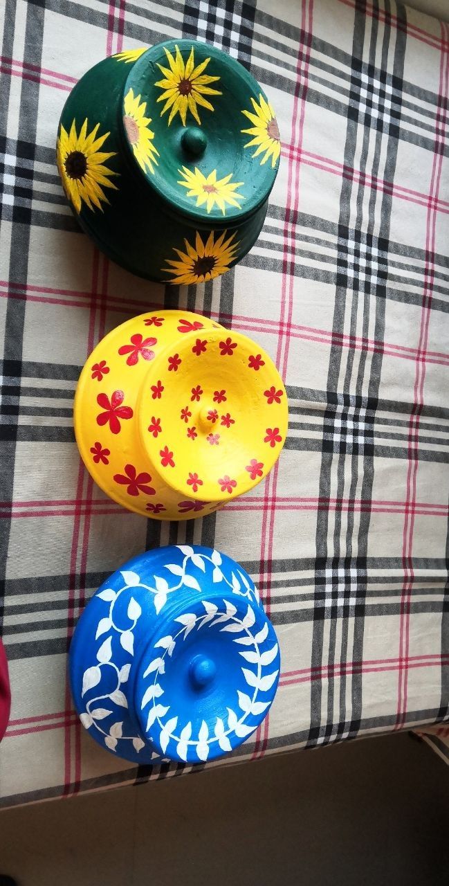 four colorful bowls sitting on top of a checkered table cloth