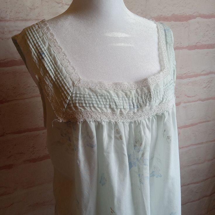 Vintage Light Blue Nightgown With darker blue and white flowers, and lovely lace  Sleeveless for super cool sleep Tag Label~ Pinehurst Tag Size~Medium Material~ 65%Polyester, 35% Cotton Find a garment you love, lay it flat and measure it, then compare! All measurements taken lying flat Shoulder to shoulder~15 inches Armpit to Armpit-20 inches Length~ 38 inches Hips- approx 24 inches There is some pilling and last photo shows a spot, this is hard material, perhaps glue??  Nightgown has been laund Lace Sleepwear With Floral Print, Floral Lace Sleepwear, Sleeveless Lace Sleepwear With Floral Print, Sleeveless Lace Trim Sleepwear For Bedtime, Sleeveless Blue Nightgown With Lace Trim, Blue Sleeveless Lace Sleepwear, Sleeveless Lace Nightgown For Home, Blue Lace Sleeveless Sleepwear, Lace Sleeveless Sleepwear For Pajama Party