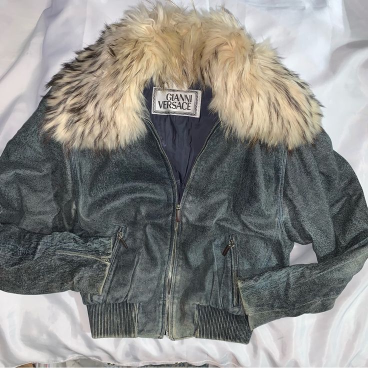 Vintage! Pre-Loved, Authentic, Gianni Versace Denim Blue Hand Colored Leather Jacket With Elasticized Waistband, Detachable Fox Fur Collar And Fully Lined In Navu Signature Medusa Head Jacquard Satin Fabric. Two Front Zip Secured Slash Pockets, Sleeves Have Zip Closure At The Wrist. Very Good Vintage Condition, Shows Use Appropriate Signs Of Prior Wear, Including Several Small White Marks At Interior Lining And Fading To The Denim Blue Paint At Exterior At Wear Points. Zip Closure At Cuffs Are Missing Signature Versace Pulls At Both Sleeves. **Size Tags Are Missing, Size Based On Photos Shown Taken On A Size 4 Dress Form. Size Extra Small Measurements 19" Back 44" Bust 18" Shoulders 21. Real Fur Coats For Women, Pennylane Jacket, Denim Blue Paint, Blue Fur Jacket, Colored Leather Jacket, Vintage Bronco, Coloured Leather Jacket, Fur Jean Jacket, Versace Jacket