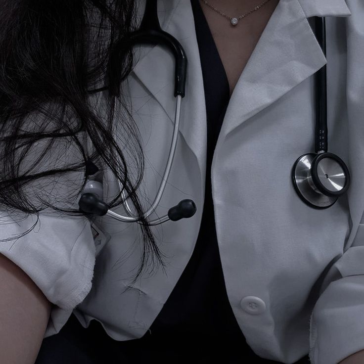 a woman wearing a white coat with a stethoscope on her chest and arm