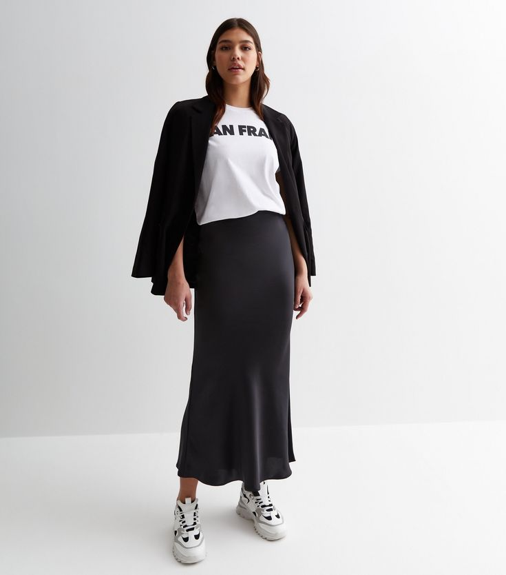 New Look Tall Black Satin Bias Midi Skirt. Tall. Designed in a stylish satin fabric, this black midi skirt is a must-have addition to your new-season edit. We love it best with a roll neck top and a faux fur jacket. High elasticated waist. Midi length. Soft satin fabric. A-line fit. Model is 5'11/180cm and wears UK 10/EU 38/US 6. Black Satin Midi Skirt Outfit, Black Silk Skirt Outfit, Satin Midi Skirt Outfits, Black Satin Skirt Outfit, Silk Skirt Outfit, Black Satin Skirt, Satin Skirt Outfit, Black Silk Skirt, Roll Neck Top