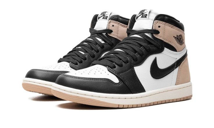 The Women’s Air Jordan 1 High OG “Latte” is a women’s-exclusive colorway of Michael Jordan’s first signature shoe with coffee-inspired details.  The “Latte” features a white leather base with black leather on the toe cap, forefoot, and eyelets.  Black leather also appears on the Swoosh.  Latte-colored leather can be found on the collar and heel.  A classic “Wings” logo can be found on the collar, while “Nike Air” branding is found on the tongue tag.  Underfoot, a Sail rubber midsole and a Latte Dark Mocha Jordan, Jordan 1 Black, Jordan Sneaker, Jordan 1 High Og, Air Jordan 1 Retro High Og, Air Jordan 1 Retro High, Nike Shox, Air Jordan 3, Air Jordan 1 High