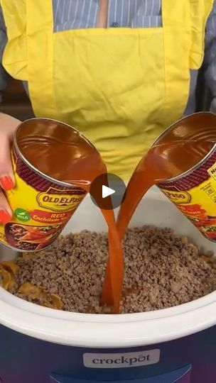 a person pouring some brown liquid into a bowl filled with ground cereal and other ingredients