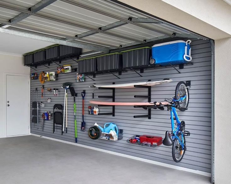 an organized garage with various items on the wall and in front of it is a bike rack