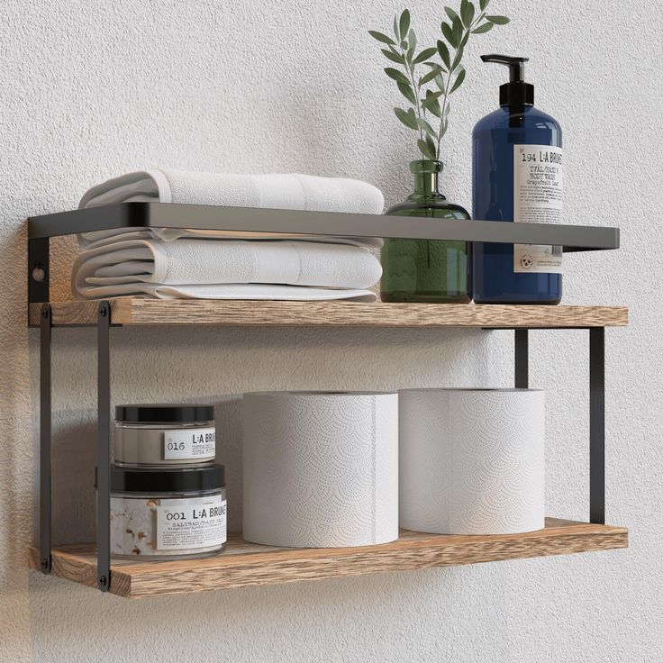 two shelves with toiletries and soaps on them next to a wall mounted towel dispenser