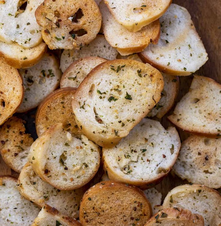 slices of garlic bread with herbs on top