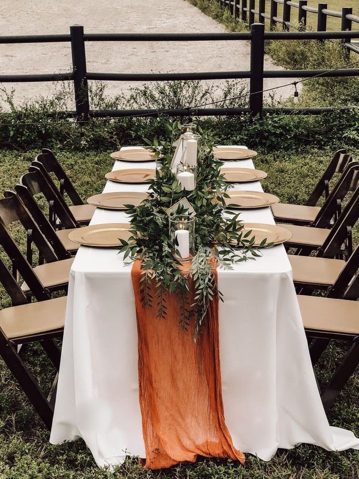 the table is set with an orange and white runner