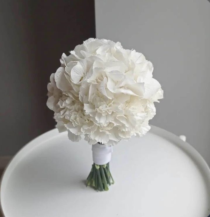 a bouquet of white flowers sitting on top of a table