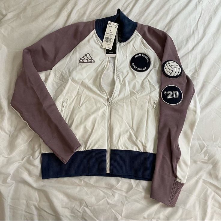 a jacket with patches on it laying on a bed