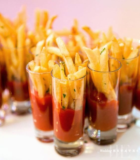 french fries with ketchup and mustard are served in small glasses on a white tray