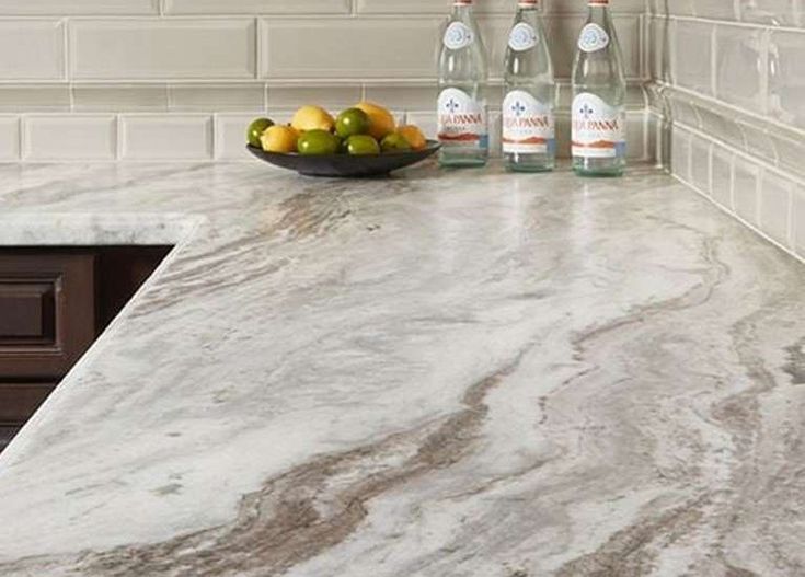 marble counter top with fruit and bottles on it