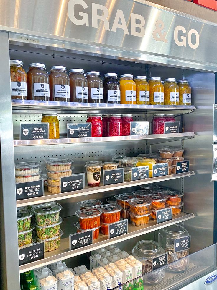 a display case filled with lots of different types of condiments and sauces