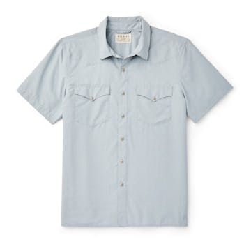 Hot days on the range call for the versatile Short-Sleeve Snap-Front Shirt. Built with a 2.6-oz. polyester and nylon blend it’s keeps you cool and provides UPF50 sun protection. The ultralight fabric wicks moisture away from you skin and has antimicrobial properties. Features Western-style front and back yokes and a snap-front closure. Straight hem with side vents. | Filson Short Sleeve Snap Front Shirt Blue Stone Size XS Relaxed Fit Shirt For Outdoor Spring Activities, Spring Outdoor Cotton Camp Shirt, Fitted Summer Tops For Outdoor, Fitted Tops For Summer Outdoor, Fitted Camp Shirt With Pockets For Summer, Fitted Summer Camp Shirt With Pockets, Cotton Short Sleeve Shirt For Spring Outdoor, Spring Outdoor Short Sleeve Cotton Shirt, Short Sleeve Tops For Outdoor Spring Activities