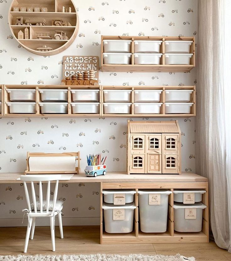 a room with some shelves and baskets on the wall next to a table, chair and desk