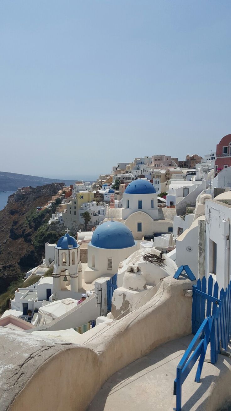 blue and white buildings overlooking the ocean on a sunny day