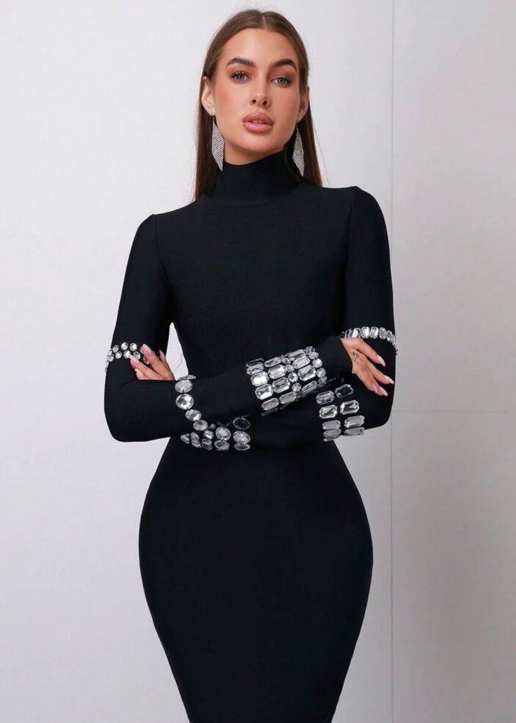 Expertly crafted with a turtleneck and long sleeves, this bodycon dress features diamond studs for a touch of glamour. Designed with a midi length and invisible zipper, it's perfect for any special occasion. Elevate your style with this sleek and sophisticated black dress. Fabric: High Stretch Material: Polyester, Elastane Black Sophisticated Dress, Bandage Dress Bodycon, Bodycon Dress With Sleeves, Long Sleeve Turtleneck, Black Bodycon Dress, Invisible Zipper, Diamond Studs, Dress Fabric, Midi Length