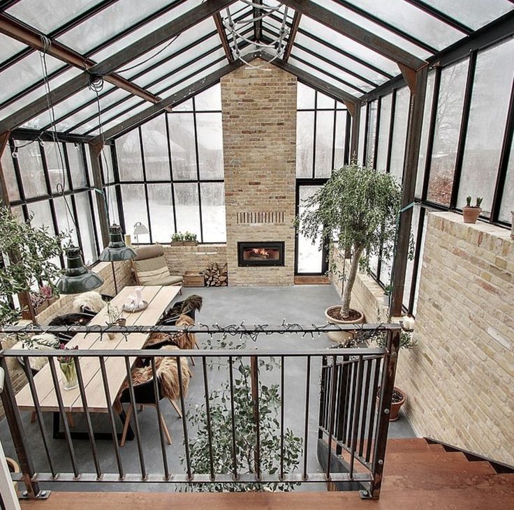 an indoor living room filled with furniture and a fire place in the middle of it