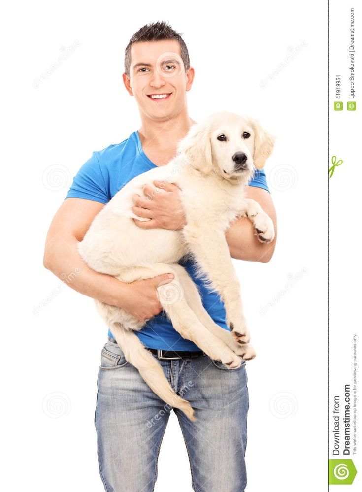 a man holding a white dog in his arms