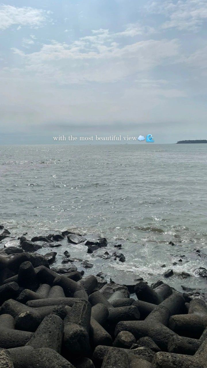 there is a large body of water with rocks on the shore