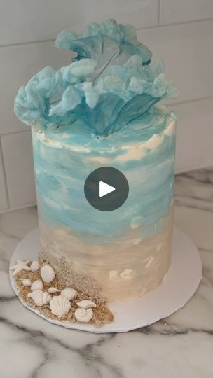 a blue and white cake sitting on top of a counter