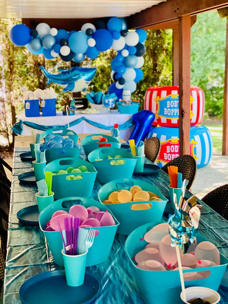 an outdoor party with blue and white decorations