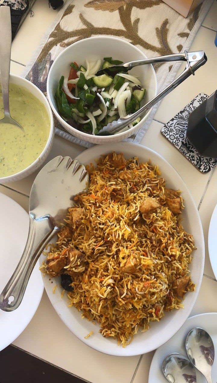 a table topped with plates and bowls filled with different types of food on top of it