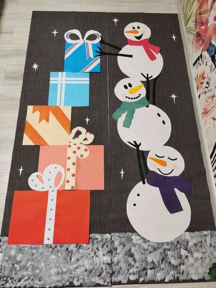 the snowmen are made out of paper and wrapped in gift boxes on the floor