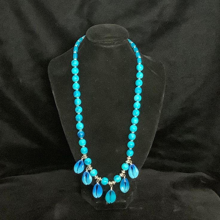 Beautiful turquoise beads coupled with matching turquoise seashells.  Measures 24" long. Turquoise Necklace With Polished Beads For Beach, Blue Shell Beaded Necklaces With Round Beads, Turquoise Jewelry With Polished Beads For Beach, Turquoise Necklace With Large Beads For Beach, Turquoise Shell Beaded Necklaces With Round Beads, Beach Turquoise Necklace With Polished Beads, Blue Turquoise Necklace With Polished Beads For Beach, Blue Turquoise Necklace With Large Beads For Beach, Blue Shell Beaded Necklace With Adjustable Fit