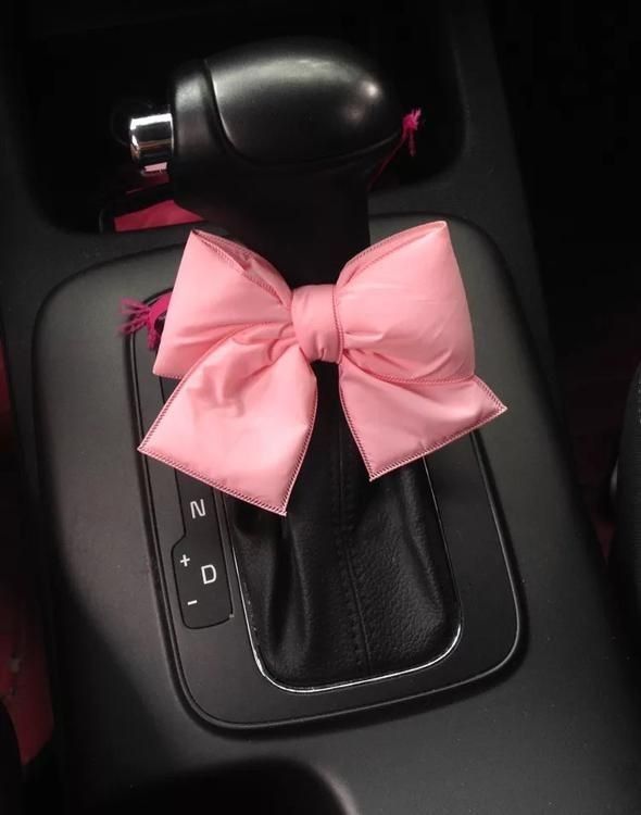 a pink bow on the center console of a car