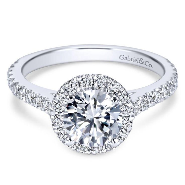 a white gold halo style engagement ring with round diamonds