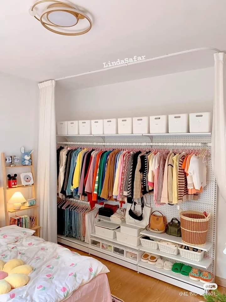 an organized closet with clothes and baskets