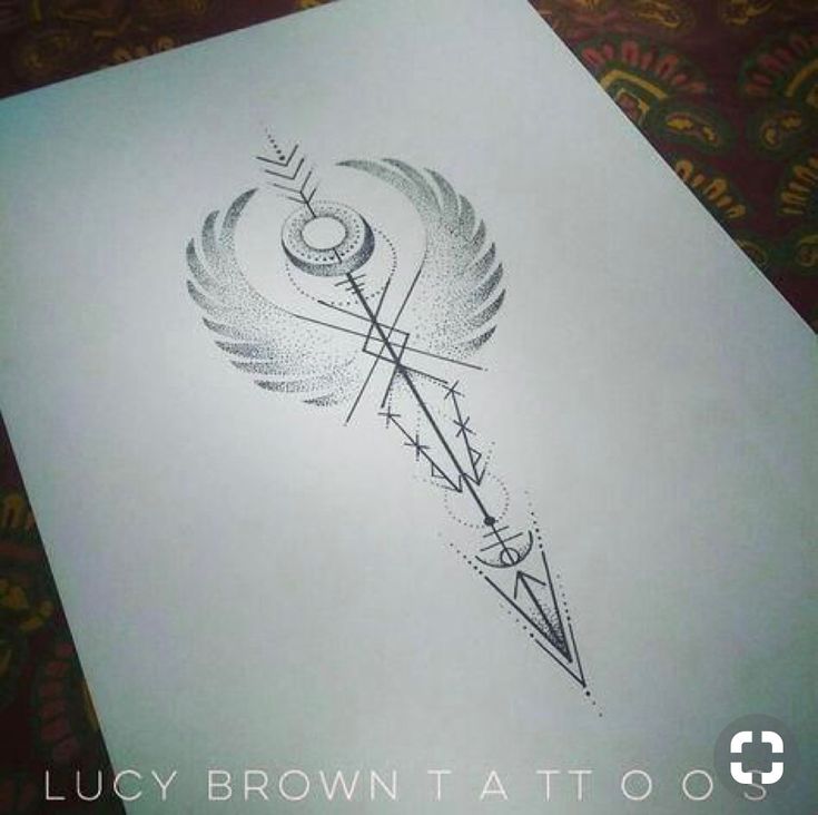 a drawing of an arrow on paper with the words lucky brown attoos above it