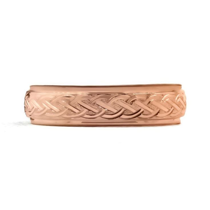 a rose gold wedding band with an intricate design on the outside, and a knot in the middle