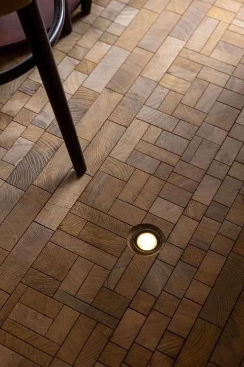 the floor is made out of wood and has a small light on top of it