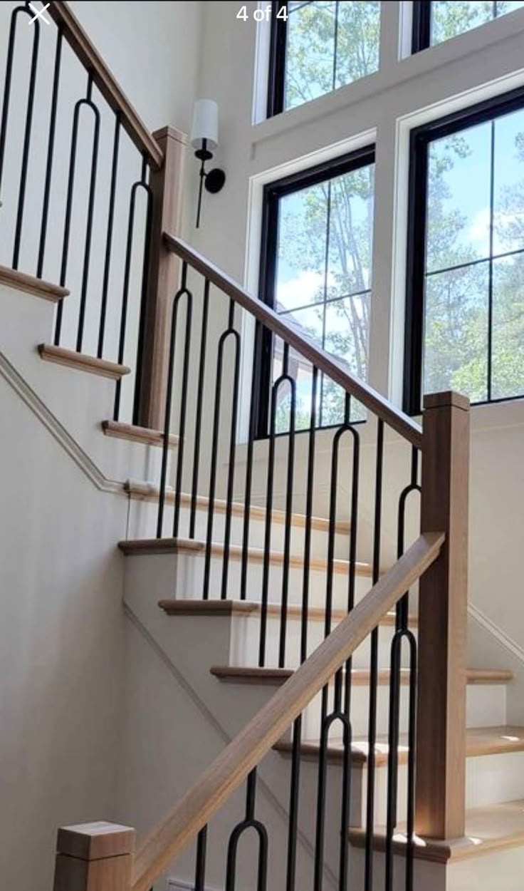 a stair case in front of two windows