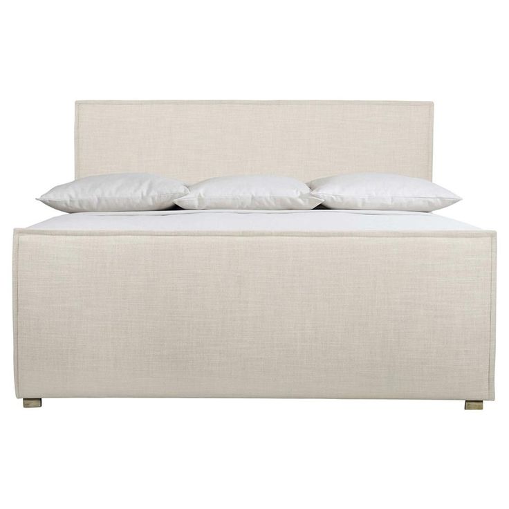 a bed with white linen and pillows on it's headboard, against a white background