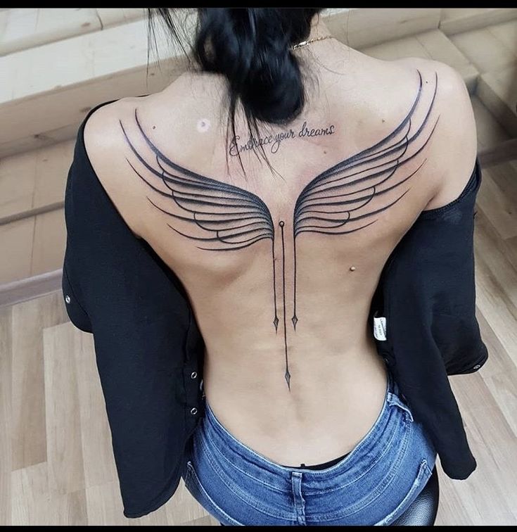 the back of a woman's body with wings on it