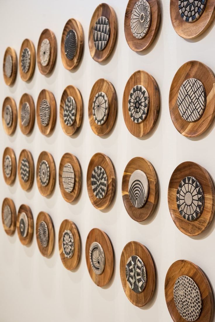 a group of wooden plates mounted to the side of a wall