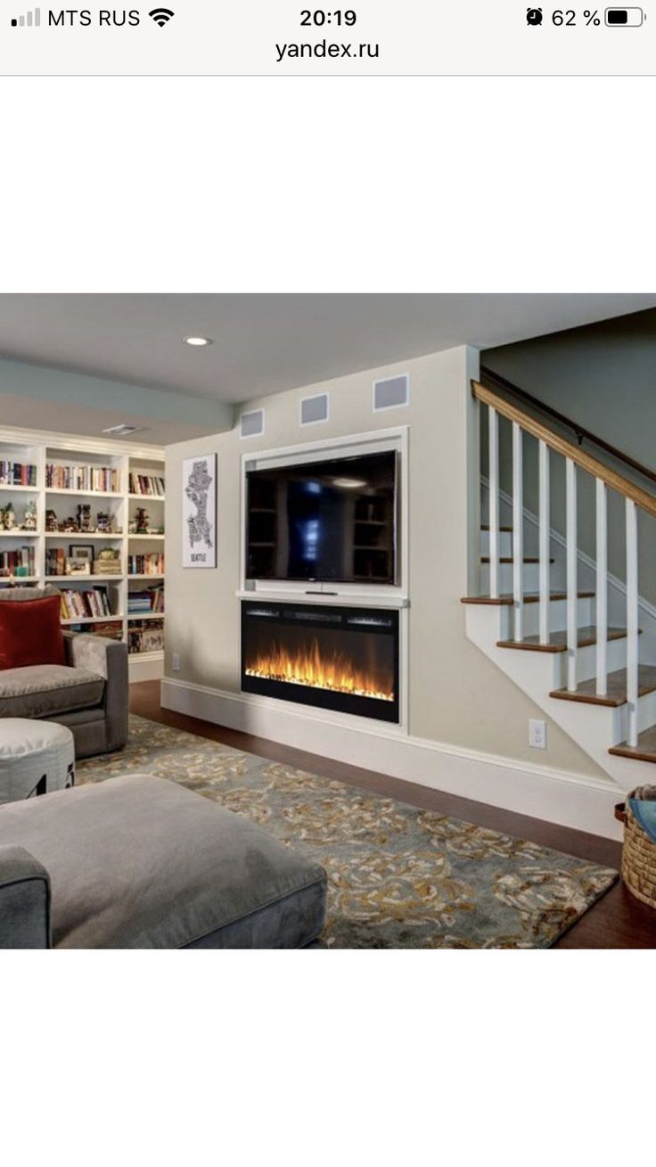 a living room filled with furniture and a flat screen tv mounted to the side of a wall