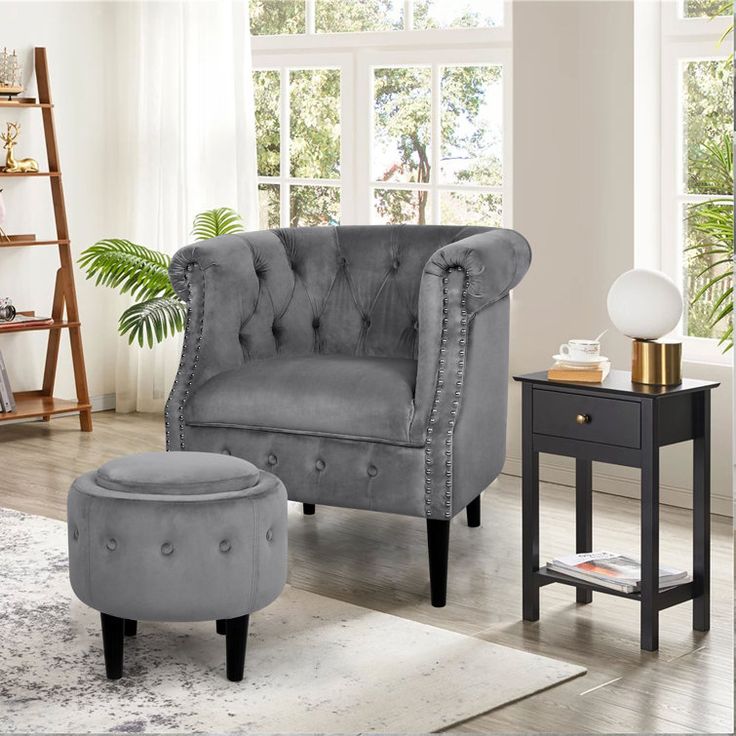 a gray chair and ottoman in a living room