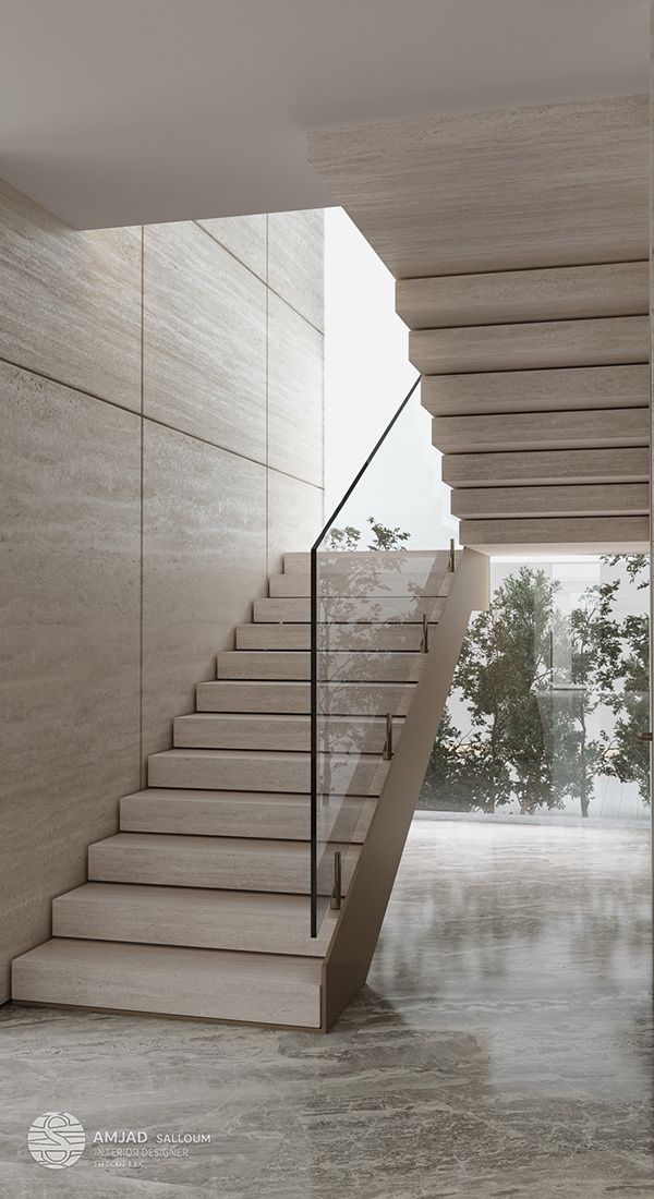 an empty room with stairs leading up to the second floor and trees in the background