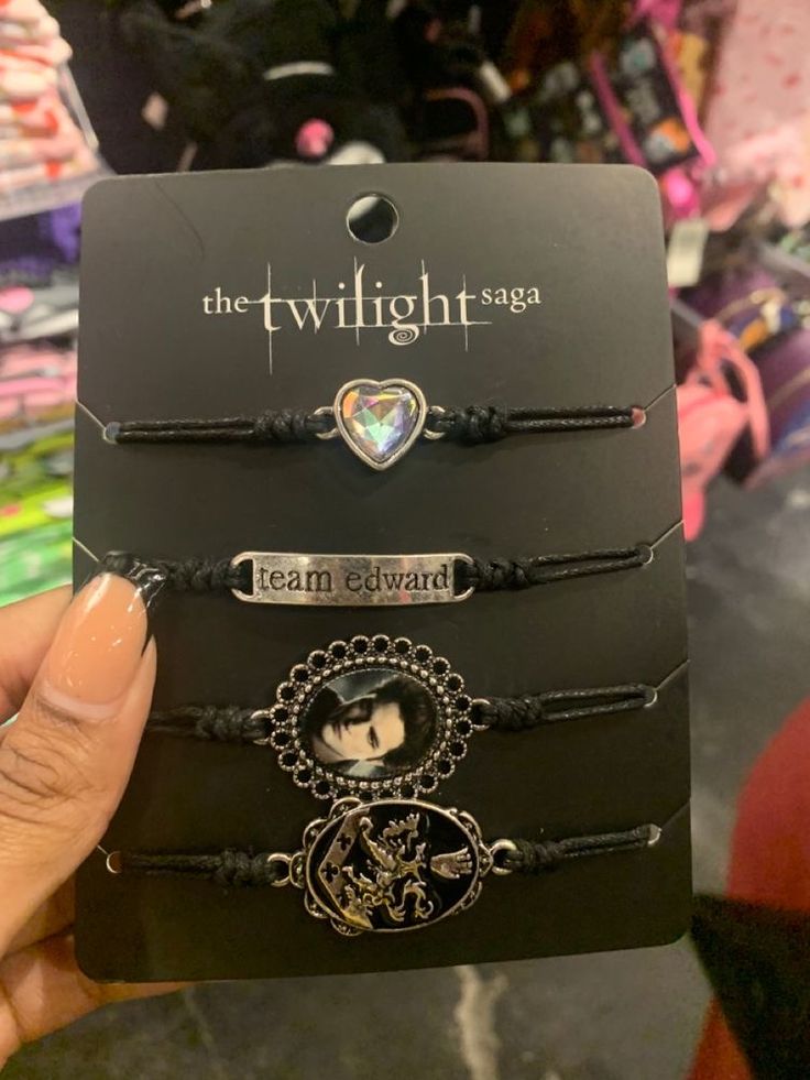 the twilight saga bracelets are on display in front of some other items at a store