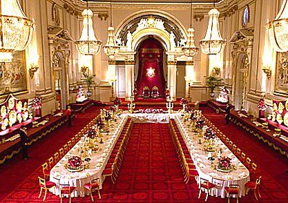 a banquet hall set up with long tables and white tablecloths on the floor